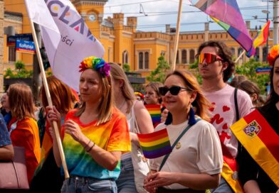 Celebrating diversity and inclusion at Wrocław Pride Parade with colorful flags and joyful participants.