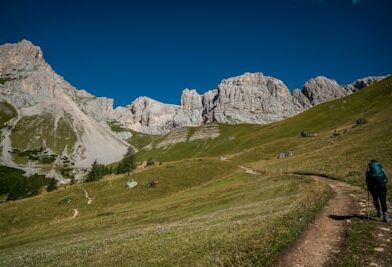 a man hiking up a trail in the mountains