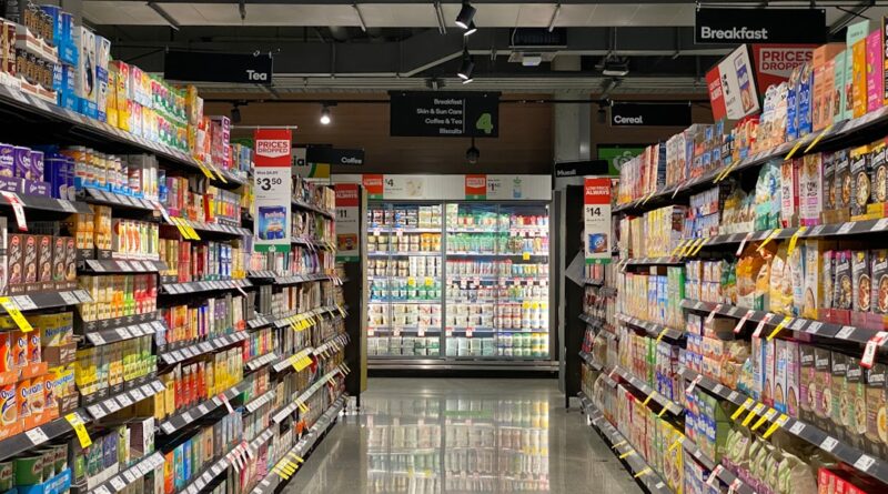 grocery store aisle with stocked shelves