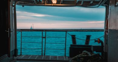 A serene view of the sea from a ferry deck in İstanbul with sailboats on the horizon.